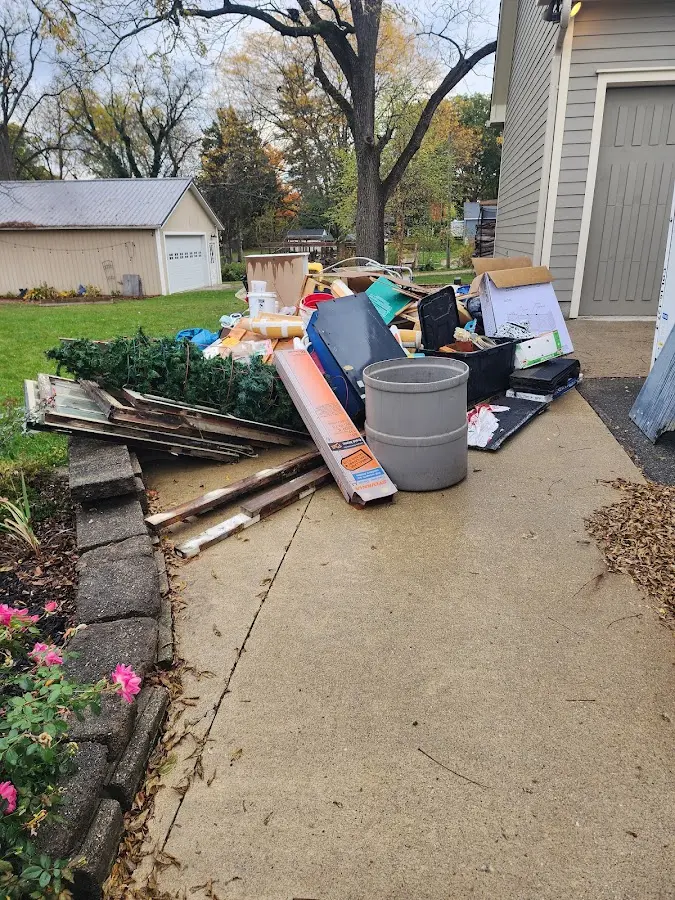 Dumpster being loaded with debris for 30 Yard Dumpster Rental in Three Oaks